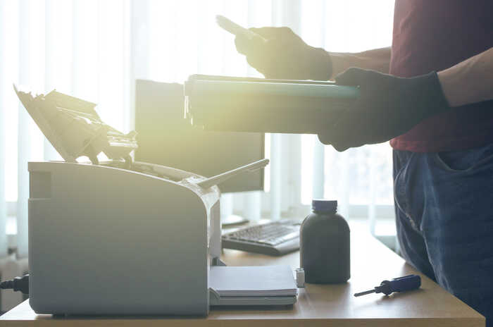 removing a toner cartridge for a printer