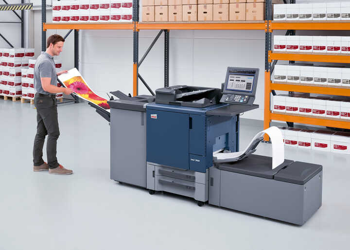 Man operating a large printer 