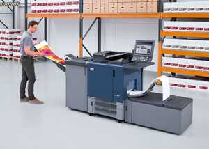 Man operating a large printer